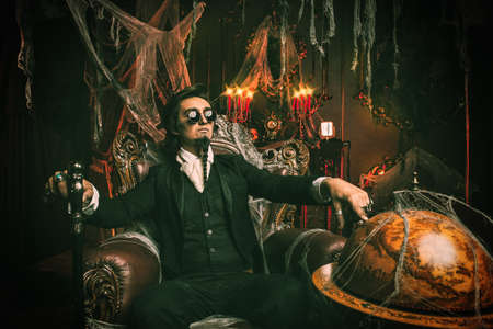 Halloween. Mysterious gloomy man in a black tailcoat in an old abandoned castle. The Dark Lord. Vampire man.の写真素材