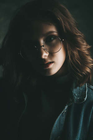Portrait of a cute girl teenager wearing spectacles. Glasses for a modern young generation. Beauty, fashion.の写真素材