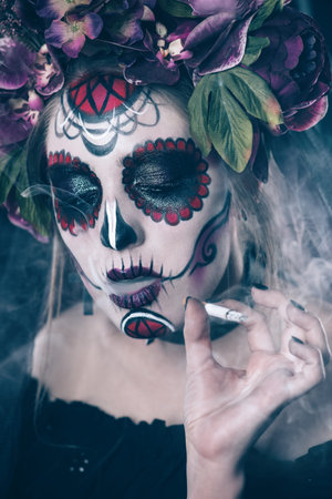 Smoking Calavera Catrina over dark scary background. Sugar skull makeup. Dia de los muertos. Day of The Dead. Halloween.  の写真素材