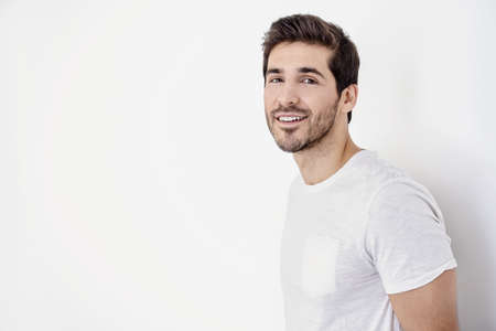 Happy young man looking at camera and smiling. Men's beauty and health.の写真素材