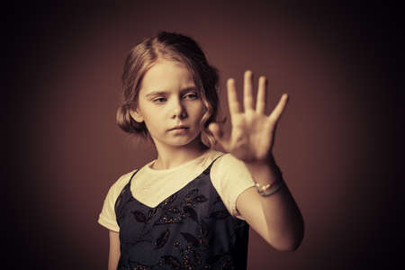Portrait of a beautiful eight year old girl with calm pensive look. Childhood concept. の写真素材