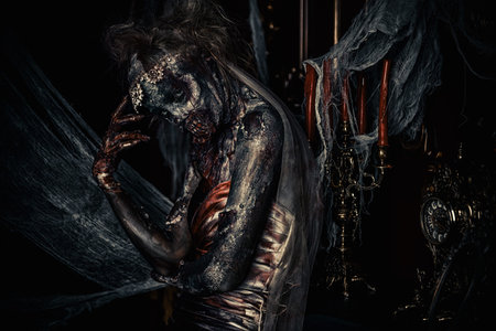 Zombie bride. Bloody dead bride woman in the old abandoned castle. Halloween. Horror.