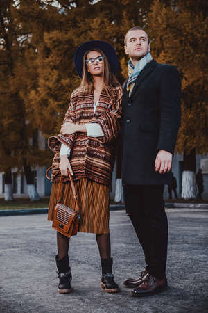 Full length portrait of a beautiful young people walking in the autumn park. Autumn fashion. の写真素材