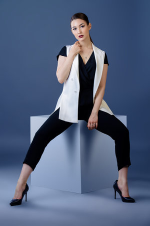 Fashion shot. Professional vogue model posing at studio. Collection of business clothes. Full length...
