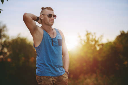 Portrait of a masculine handsome man in casual clothes standing outdoor. Men's fashion. の写真素材