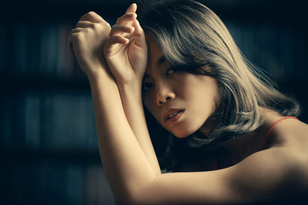 Close-up portrait of a sad, pensive asian woman. Asian beauty. Studio shot.