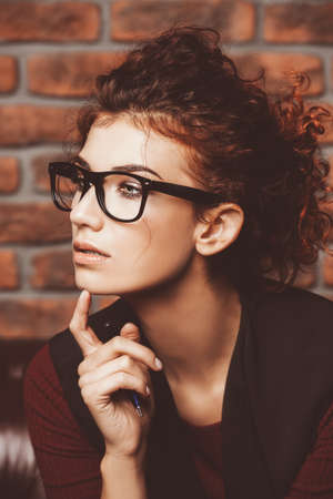 Portrait of a contemporary pensive business woman at the office. Contemporary business.の写真素材