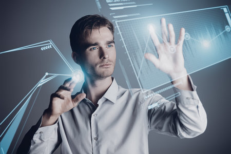 Contemporary businessman hand touching virtual screen. Studio shot. Copy space. Modern business...