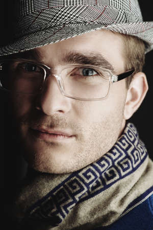 Male beauty, fashion. Portrait of a handsome smiling man wearing elegant clothing.の写真素材