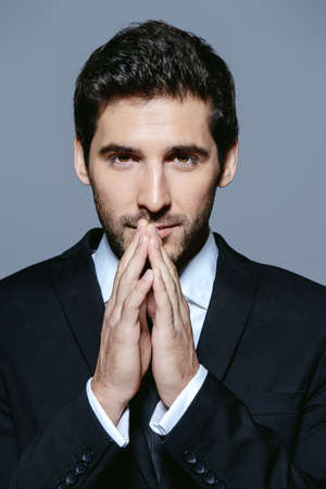 Portrait of a serious contemporary businessman in a suit. Studio shot.の写真素材