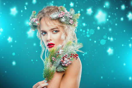 Portrait of a beautiful young woman with christmas tree in hairstyle and holiday make-up. Beauty, fashion.の写真素材