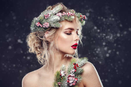 Portrait of a beautiful young woman with christmas tree in hairstyle and holiday make-up. Beauty, fashion.の写真素材