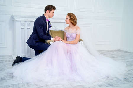 The enamored groom knelt down before his bride. Love concept. Wedding fashion.の写真素材