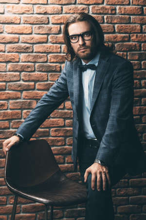 Portrait of a handsome young man in elegant classic suit and glasses. Men's beauty, fashion. Business style.の写真素材