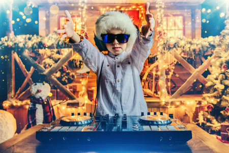 Emotional little boy-DJ is having a party near the house of Santa Claus decorated with lights....