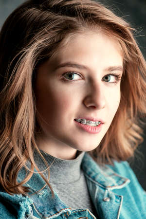 Cute girl teenager wearing dental braces. Healthcare, stomatology and orthodontics.の写真素材