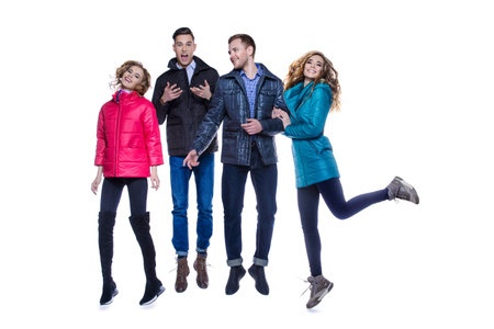 Two young couples in winter clothes in a studio.Fashion shot.の写真素材