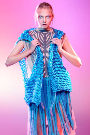 Vogue shot of a female model posing at studio. Fashion collection. Portrait over pink background.の写真素材