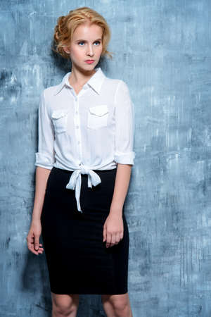Beautiful young business woman smiling at camera. Fashion, business style.の写真素材