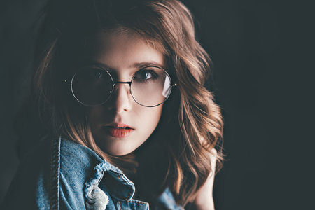 Portrait of a cute girl teenager wearing spectacles. Glasses for a modern young generation. Beauty,...