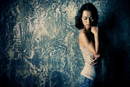 Portrait of a beautiful sensual asian woman over grunge background. Asian beauty. Studio shot.の写真素材