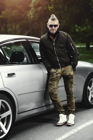 Portrait of a handsome mature man near his car.