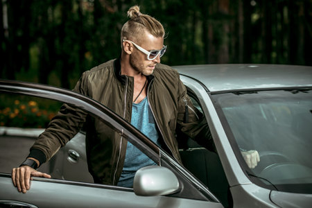 Portrait of a handsome mature man near his car.