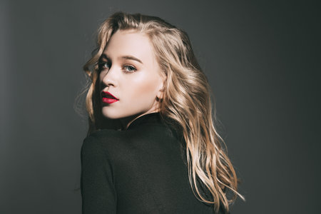 Portrait of a attractive young woman with blonde wavy hair. Beauty, fashion concept. Cosmetics and make-up.の写真素材