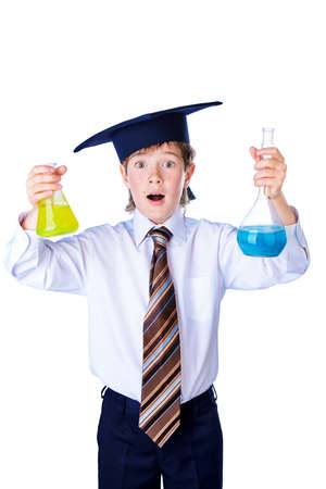 Smart student boy in white shirt, a tie and academic hat holds a flask with liquid. Educational concept. Isolated over white.の写真素材