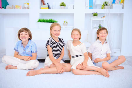 Four funny children spend time together at home. Child concept.  Kid's fashion.の写真素材