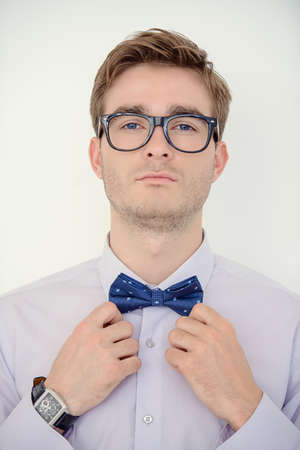 Men's beauty, fashion. Well-groomed young man wearing elegant suit and bow-tie.の写真素材