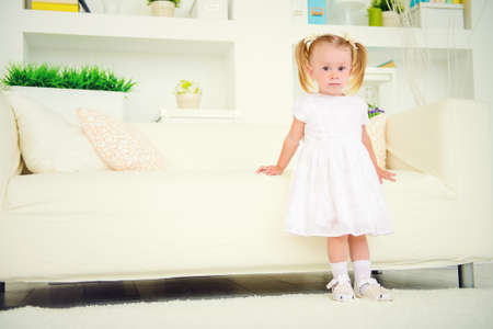 Cute two year old girl playing at home. Happy childhood.の写真素材