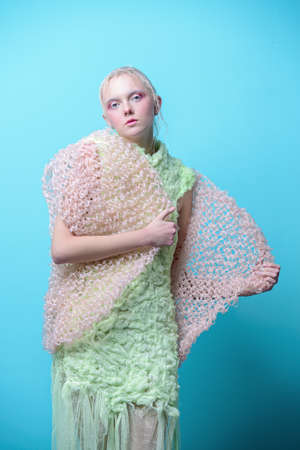 Full length fashion portrait of a female model performing designer collection. Avant-garde style. Studio shot.の写真素材