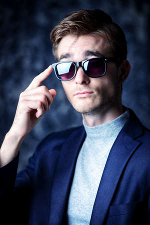 Business concept. Portrait of a handsome businessman wearing suit and sunglasses.の写真素材