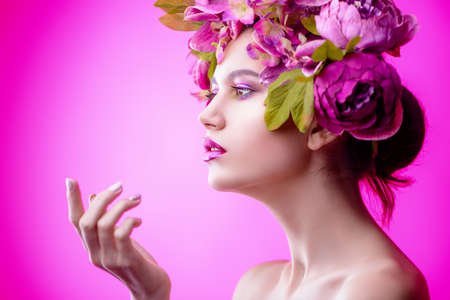 Sensual spring lady in a wreath of flowers. Inspiration of spring and summer. Perfume, cosmetics concept.の写真素材