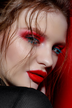 Fashion and make-up concept. Close-up portrait of an attractive young woman with creative makeup...