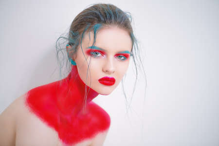 Portrait of a beautiful young woman with creative makeup and body painting. White background. Fashion and make-up concept.の写真素材