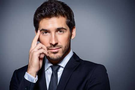 Portrait of a contemporary businessman in a suit. Studio shot.の写真素材