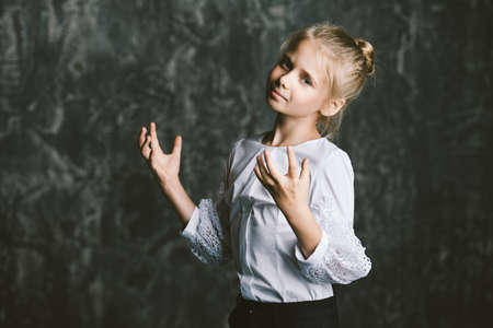 Portrait of a beautiful eight year old girl with calm pensive look. Childhood concept. の写真素材