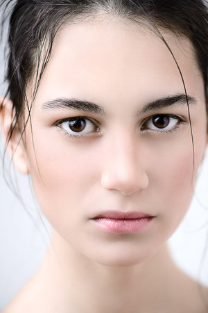 Beauty portrait. Sensual brunette girl with healthy shiny skin. Beauty, natural cosmetics concept.の写真素材