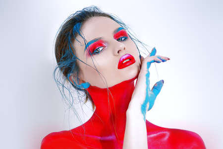 Portrait of a beautiful young woman with creative makeup and body painting. White background. Fashion and make-up concept.の写真素材