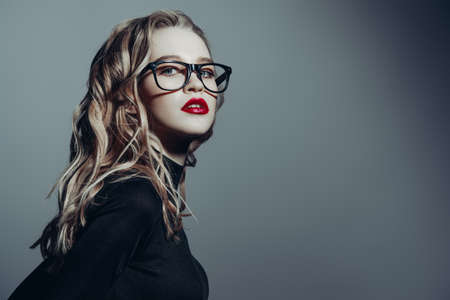 Attractive young woman in spectacles. Studio shot. Beauty, fashion concept. Optics style.の写真素材