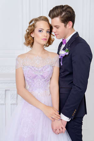 Loving bride and groom stand in tender embrace. Wedding fashion.の写真素材