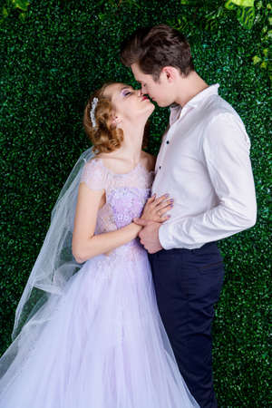 Loving bride and groom stand in tender embrace. Wedding fashion.の写真素材