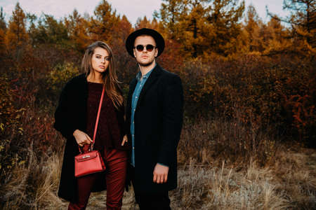 Portrait of a beautiful young people walking in the autumn park. Autumn fashion. の写真素材