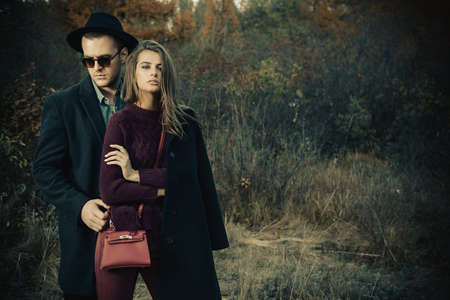 Portrait of a beautiful young people walking in the autumn park. Autumn fashion. の写真素材
