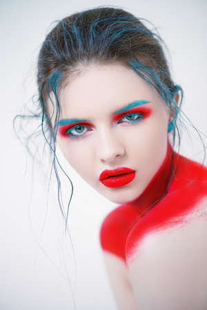 Portrait of a beautiful young woman with creative makeup and body painting. White background. Fashion and make-up concept.の写真素材