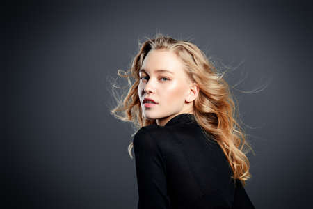 Portrait of a attractive young woman with blonde wavy hair. Beauty, fashion concept. Cosmetics and make-up.の写真素材