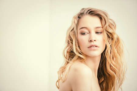 Portrait of a beautiful blonde woman with natural make-up. Beauty, haircare, cosmetics concept. Healthcare. White background.の写真素材