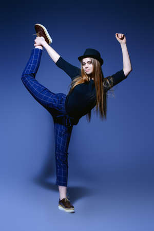 Full length portrait a stylish fashion model in casual clothes over gray background. Beauty, fashion concept. Studio shot.の写真素材